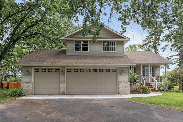 6956 Delarosa Ct, Inver Grove Heights, MN 55076 - view of front of house with driveway, brick siding, covered porch, a shingled roof, and an attached garage