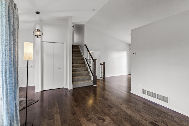 6956 Delarosa Ct, Inver Grove Heights, MN 55076 - unfurnished living room featuring vaulted ceiling, wood finished floors, and stairway