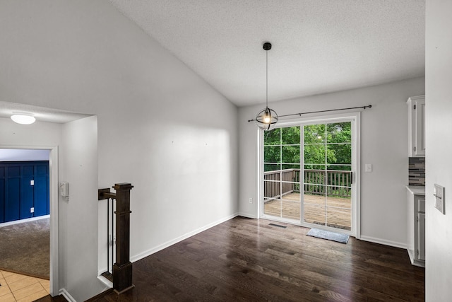 6956 Delarosa Ct, Inver Grove Heights, MN 55076 - unfurnished dining area featuring wood finished floors, a textured ceiling, and vaulted ceiling
