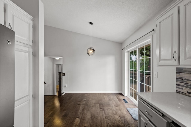 6956 Delarosa Ct, Inver Grove Heights, MN 55076 - unfurnished dining area with dark wood-style flooring and a textured ceiling