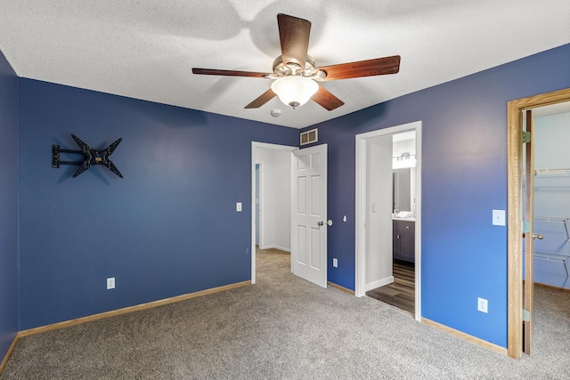 6956 Delarosa Ct, Inver Grove Heights, MN 55076 - unfurnished bedroom featuring carpet, a walk in closet, ensuite bathroom, a closet, and a ceiling fan