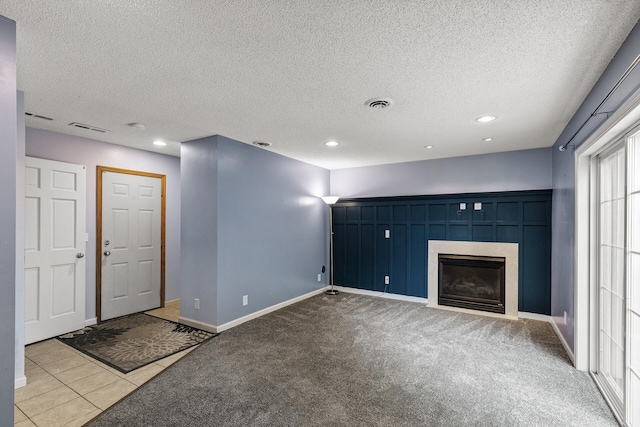 6956 Delarosa Ct, Inver Grove Heights, MN 55076 - unfurnished living room with a textured ceiling, a tiled fireplace, recessed lighting, carpet flooring, and tile patterned floors