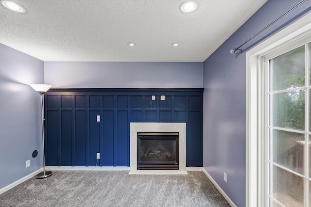 6956 Delarosa Ct, Inver Grove Heights, MN 55076 - unfurnished living room featuring carpet, a textured ceiling, a fireplace with flush hearth, and recessed lighting