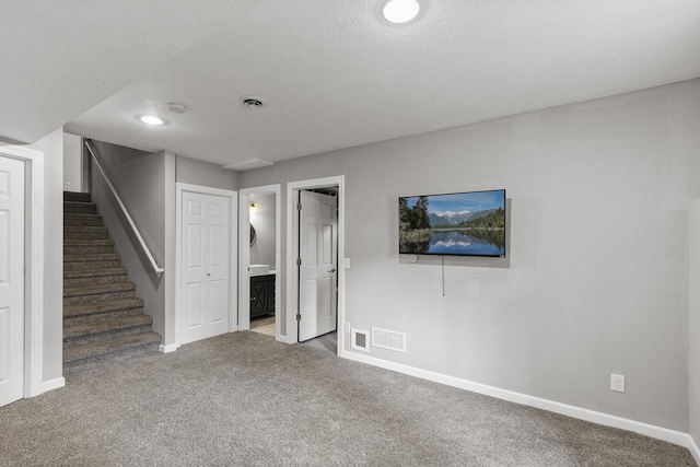 6956 Delarosa Ct, Inver Grove Heights, MN 55076 - unfurnished living room featuring carpet flooring, stairs, and a textured ceiling