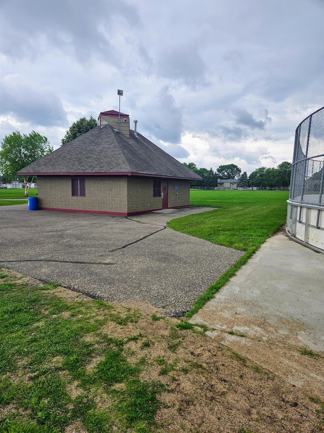 6956 Delarosa Ct, Inver Grove Heights, MN 55076 - view of side of property with a yard, a shingled roof, and a chimney