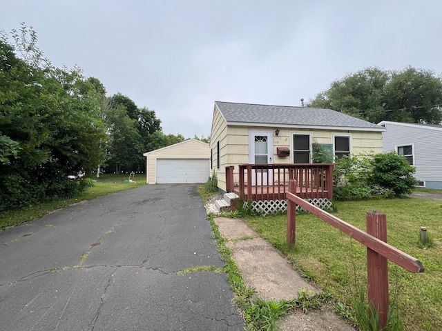 1717 Cottage Ln, Virginia, MN 55792 - view of front of home featuring a detached garage, an outbuilding, a front lawn, and a deck