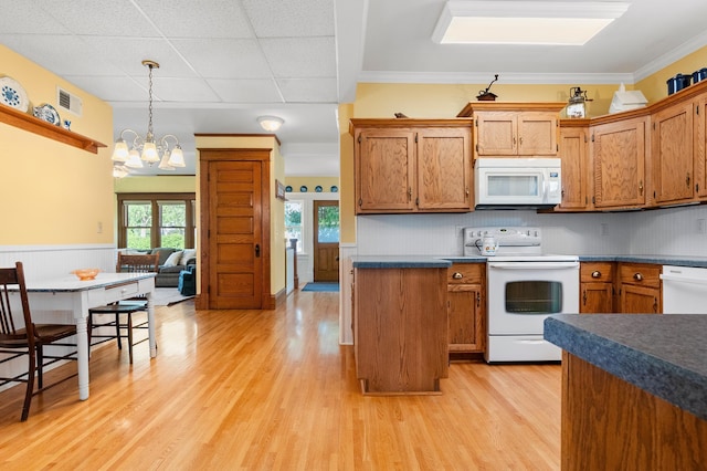 922 Fillmore St, Alexandria, MN 56308 - kitchen featuring white appliances, light wood finished floors, dark countertops, a chandelier, and plenty of natural light