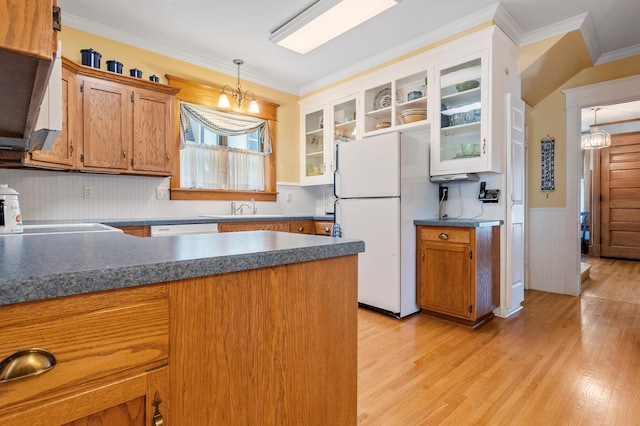 922 Fillmore St, Alexandria, MN 56308 - kitchen featuring freestanding refrigerator, a chandelier, ornamental molding, dark countertops, and pendant lighting