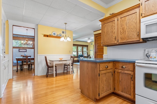 922 Fillmore St, Alexandria, MN 56308 - kitchen featuring white appliances, a chandelier, light wood-style floors, a paneled ceiling, and dark countertops