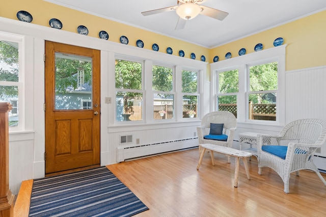 922 Fillmore St, Alexandria, MN 56308 - sunroom with a baseboard radiator, wood finished floors, and ornamental molding