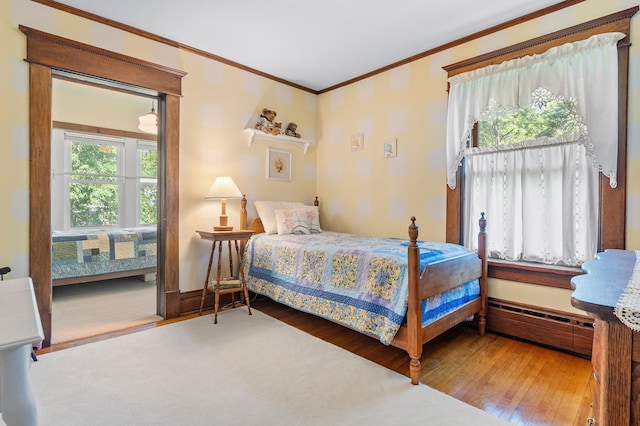 922 Fillmore St, Alexandria, MN 56308 - bedroom with crown molding, wood-type flooring, and baseboard heating