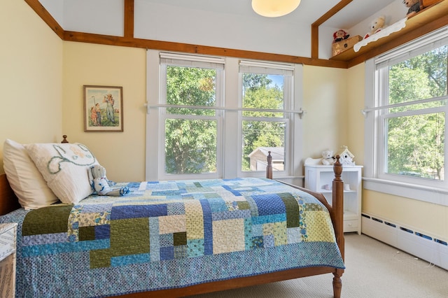 922 Fillmore St, Alexandria, MN 56308 - carpeted bedroom featuring multiple windows and a baseboard radiator