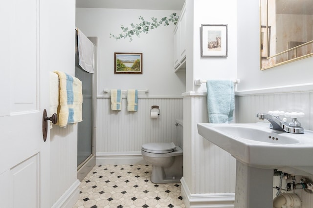 922 Fillmore St, Alexandria, MN 56308 - full bathroom featuring a wainscoted wall, a stall shower, and tile patterned floors