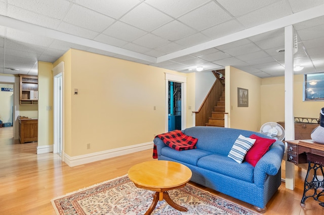922 Fillmore St, Alexandria, MN 56308 - living room featuring a drop ceiling, light wood-style floors, and stairway