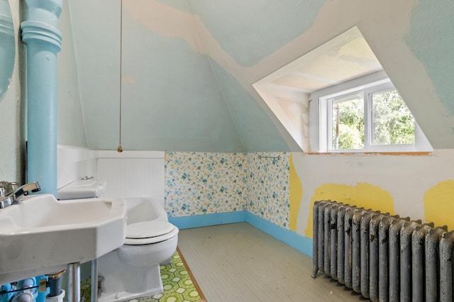 922 Fillmore St, Alexandria, MN 56308 - bathroom with radiator heating unit, wood finished floors, and wallpapered walls