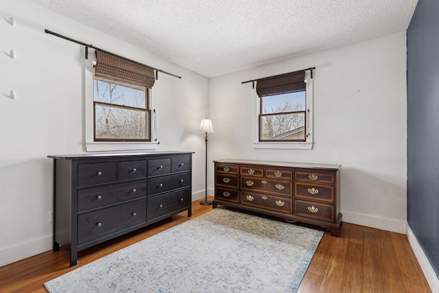 1659 Heron Ln, Mound, MN 55364 - bedroom featuring wood finished floors, a textured ceiling, and baseboards