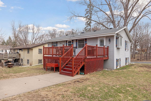 1659 Heron Ln, Mound, MN 55364 - ranch-style house featuring a wooden deck, a front lawn, and an outdoor fire pit