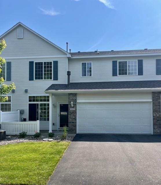 18245 69th Pl N, Maple Grove, MN 55311 - view of front of house featuring asphalt driveway, a garage, and cooling unit