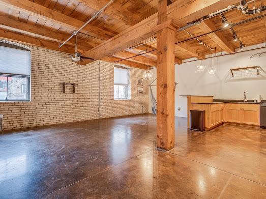 127 5th St NE Unit G08, Minneapolis, MN 55413 - basement featuring wood ceiling, brick wall, and a sink