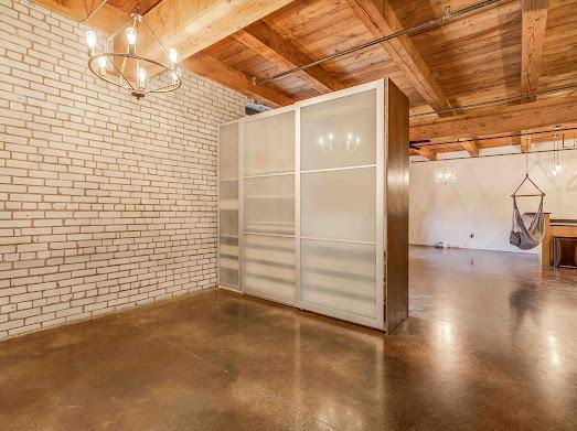 127 5th St NE Unit G08, Minneapolis, MN 55413 - bathroom featuring wooden ceiling with exposed beams and brick wall