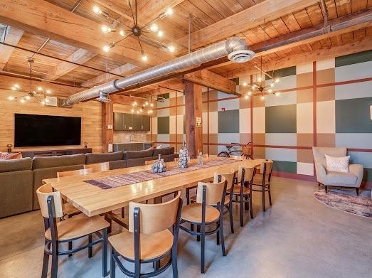 127 5th St NE Unit G08, Minneapolis, MN 55413 - dining space with concrete floors, wood ceiling with exposed beams, and a chandelier
