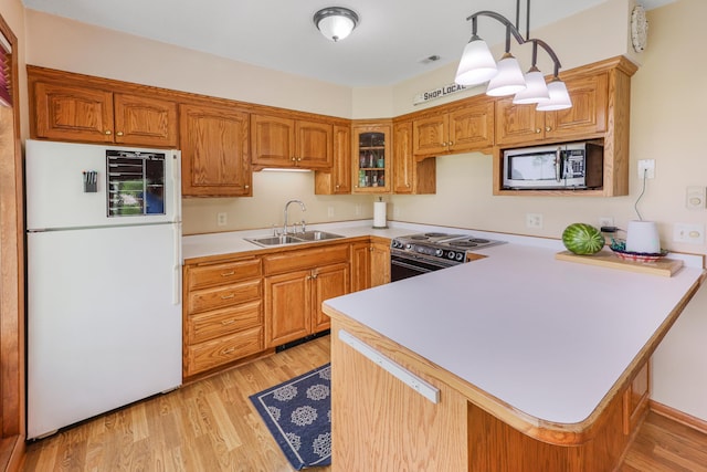4195 25th St NE, Sauk Rapids, MN 56379 - kitchen featuring freestanding refrigerator, stainless steel microwave, electric range oven, a sink, and a peninsula
