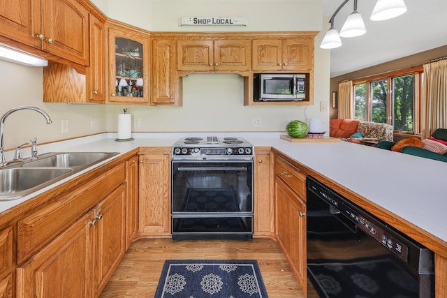 4195 25th St NE, Sauk Rapids, MN 56379 - kitchen featuring black appliances, a sink, light wood-style flooring, and light countertops