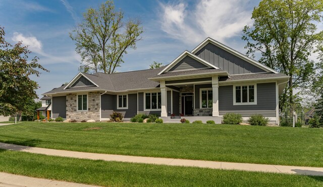3039 Lady Slipper Ln SW, Rochester, MN 55902 - craftsman-style house featuring stone siding, a front lawn, board and batten siding, and a porch