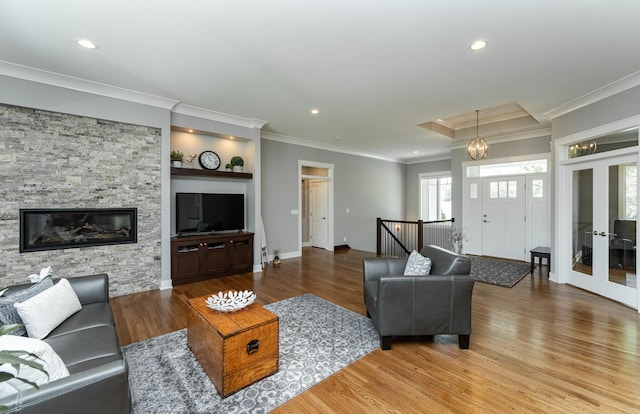 3039 Lady Slipper Ln SW, Rochester, MN 55902 - living area featuring wood finished floors, recessed lighting, ornamental molding, french doors, and a fireplace
