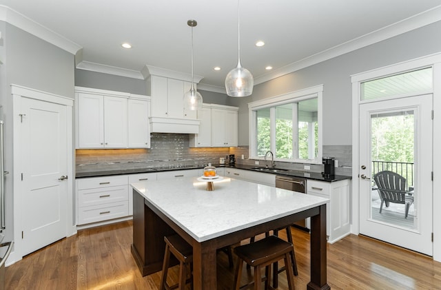 3039 Lady Slipper Ln SW, Rochester, MN 55902 - kitchen with stainless steel dishwasher, decorative backsplash, dark wood-style flooring, crown molding, and white cabinets
