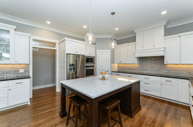 3039 Lady Slipper Ln SW, Rochester, MN 55902 - kitchen featuring stainless steel appliances, a breakfast bar area, decorative backsplash, white cabinetry, and ornamental molding