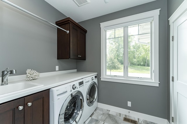 3039 Lady Slipper Ln SW, Rochester, MN 55902 - laundry area with cabinet space, washing machine and dryer, and light marble finish floors