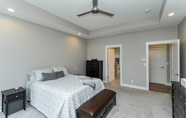 3039 Lady Slipper Ln SW, Rochester, MN 55902 - bedroom featuring light carpet, recessed lighting, a ceiling fan, ensuite bathroom, and a tray ceiling