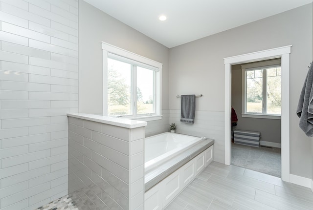 3039 Lady Slipper Ln SW, Rochester, MN 55902 - bathroom with plenty of natural light, a bath, and a walk in shower