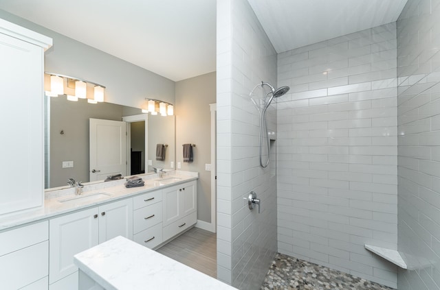 3039 Lady Slipper Ln SW, Rochester, MN 55902 - bathroom featuring walk in shower, double vanity, and wood finished floors