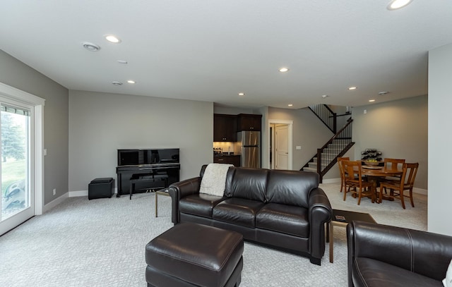 3039 Lady Slipper Ln SW, Rochester, MN 55902 - living area featuring light carpet, stairs, and recessed lighting