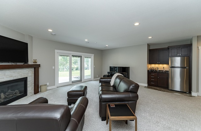 3039 Lady Slipper Ln SW, Rochester, MN 55902 - living area featuring light carpet, recessed lighting, a stone fireplace, and bar area