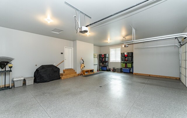 3039 Lady Slipper Ln SW, Rochester, MN 55902 - garage with a garage door opener and freestanding refrigerator