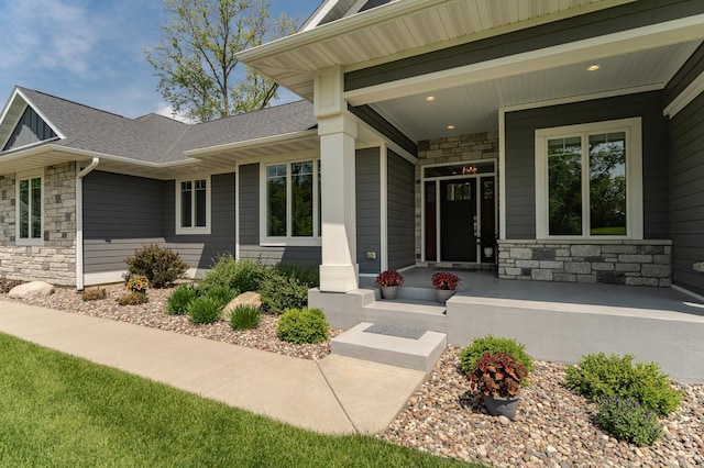 3039 Lady Slipper Ln SW, Rochester, MN 55902 - doorway to property with stone siding, a porch, and a shingled roof