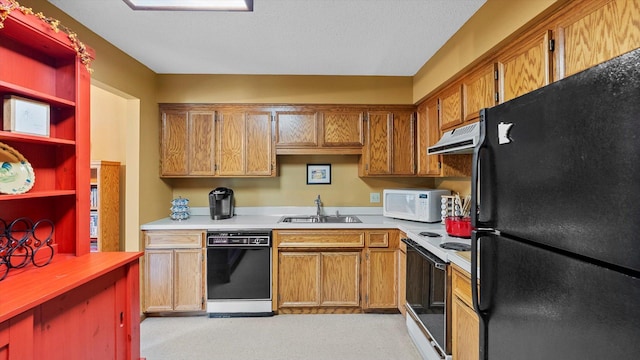 2606 Lake Court Dr, Mounds View, MN 55112 - kitchen featuring black appliances, a sink, under cabinet range hood, light countertops, and light carpet