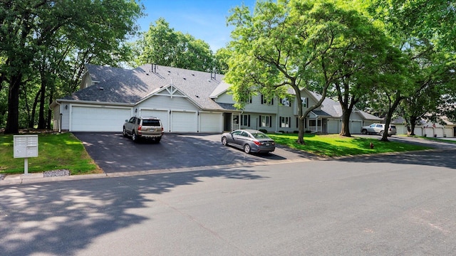 2606 Lake Court Dr, Mounds View, MN 55112 - townhome / multi-family property featuring asphalt driveway, a garage, and a front yard