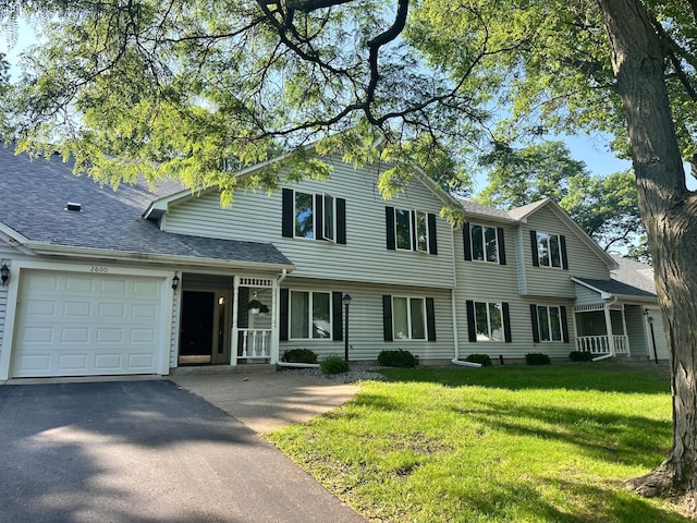 2606 Lake Court Dr, Mounds View, MN 55112 - view of front of home featuring an attached garage, driveway, a front lawn, and roof with shingles