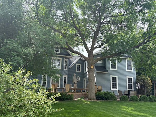 1710 Maple Ave, Benson, MN 56215 - view of front of home with a front yard, a deck, and roof with shingles