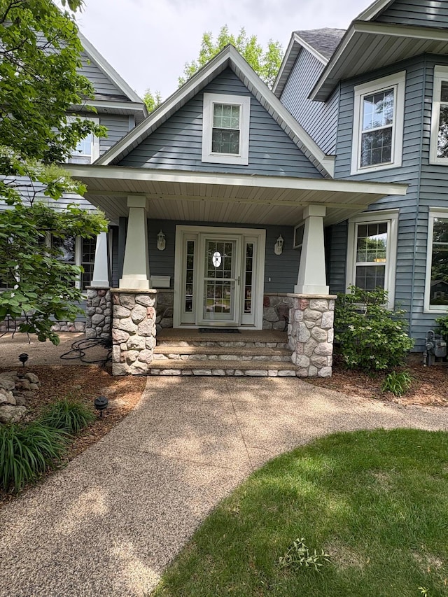 1710 Maple Ave, Benson, MN 56215 - property entrance featuring covered porch and stone siding