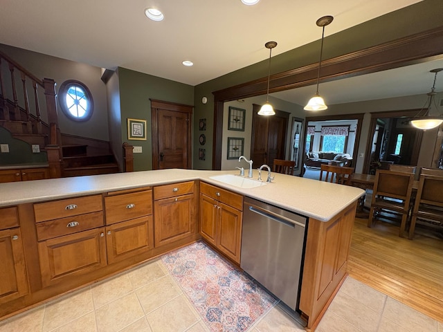 1710 Maple Ave, Benson, MN 56215 - kitchen with dishwasher, a sink, light tile patterned floors, light countertops, and brown cabinets