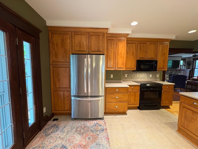 1710 Maple Ave, Benson, MN 56215 - kitchen featuring black appliances, brown cabinetry, light countertops, backsplash, and recessed lighting