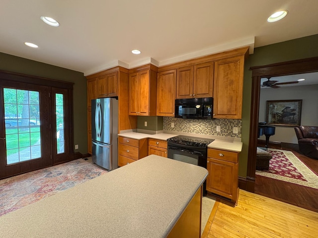 1710 Maple Ave, Benson, MN 56215 - kitchen featuring black appliances, brown cabinets, light countertops, recessed lighting, and decorative backsplash