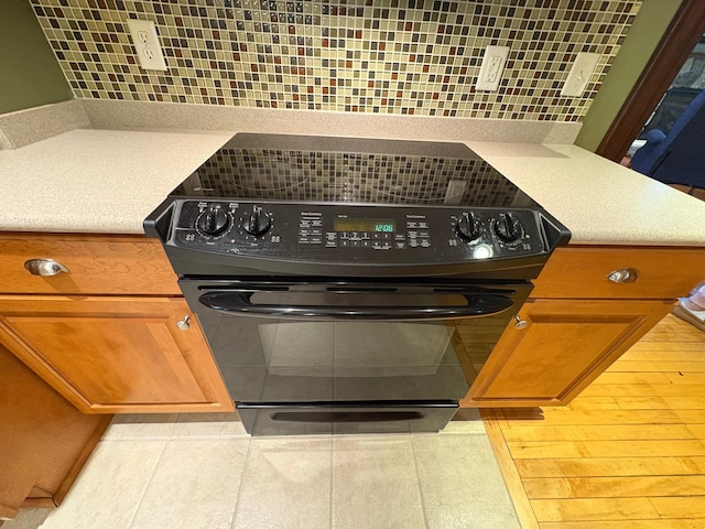 1710 Maple Ave, Benson, MN 56215 - kitchen view of electric range, tasteful backsplash, and light countertops