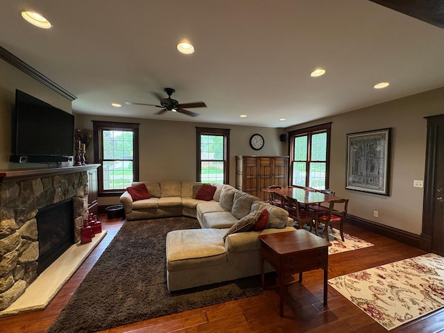 1710 Maple Ave, Benson, MN 56215 - living area with a stone fireplace, recessed lighting, dark wood-type flooring, ceiling fan, and baseboards