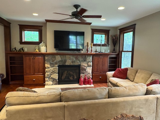 1710 Maple Ave, Benson, MN 56215 - living area featuring wood finished floors, a ceiling fan, recessed lighting, and a stone fireplace